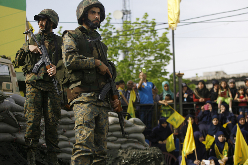 Hizbollah fighters stand guard during a rally commemorating ‘Liberation Day’, which marks the withdrawal of the Israeli army from southern Lebanon in 2000, in the southern town of Nabatiyeh on Sunday (AP photo)